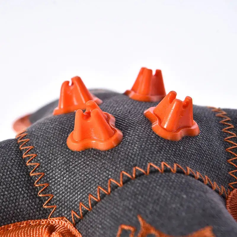 Top view of squeaky teeth cleaning dog toy with rubber and plush